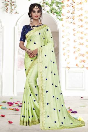 This Season Is About Subtle Shades And Pastel Play, So Grab This Designer Saree In Pastel Green Color Paired With Contrasting Navy Blue Colored Blouse. This Saree Is Fabricated On Shimmer Georgette Paired With Brocade Fabricated Blouse. Buy Now.