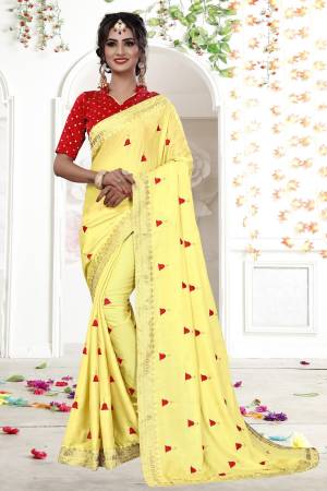 Celebrate This Festive Season Wearing This Designer Saree In Yellow Color Paired With Contrasting Red Colored Blouse. This Saree Is Fabricated On Shimmer Georgette Paired With Brocade Fabricated Blouse. It Has Pretty Elegant Embroidery All Over The Saree.