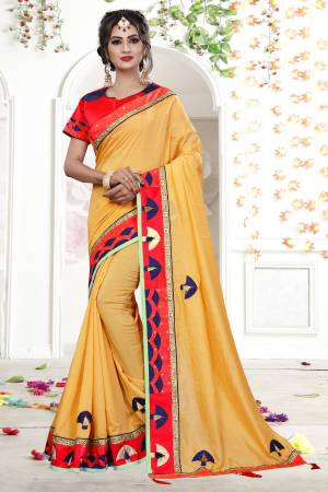 Celebrate This Festive Season Wearing This Designer Saree In Yellow Color Paired With Contrasting Red Colored Blouse. This Saree Is Fabricated On Fancy Georgette Paired With Art Silk Fabricated Blouse. It Has Pretty Elegant Embroidery All Over The Saree.