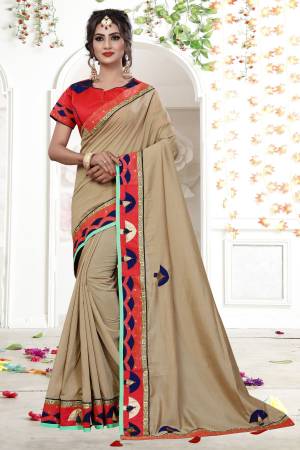 Shine Bright Wearing This Designer Saree In Beige Color Paired With Contrasting Red Colored Blouse. This Saree Is Fancy Georgette Based Fabric Paired With Art Silk Fabricated Blouse. Its Pretty Elegant Embroidery Will Earn You Lots Of Compliments From Onlookers.