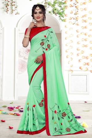 You Will Definitely Earn Lots Of Compliments Wearing This Designer Saree In Turquoise Blue Color Paired With Contrasting Red Colored Blouse. This Saree Is Fabricated On Fancy Georgette Paired With Art Silk Blouse. It Pretty Colorful Thread Work Gives A Prettiest Look Like Never Before.