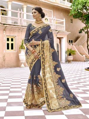 Flaunt Your Rich and Elegant Taste Wearing This Designer Saree In Grey Color Paired With Grey Colored Blouse. This Saree IS Fabricated On Georgette paired With Art Silk Fabricated Blouse. It Is Beautified With Heavy Embroidery Which Will earn You Lots Of Compliments From Onlookers.