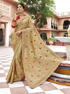 Elegant And Heavy Looking Saree Is Here In Beige Color Paired With Red Colored Blouse. This Saree Is Fabricated On Georgette Paired With Art Silk Fabricated Blouse. It Has Embroidery All Over The Pallu And Also Over the Saree Panel. Buy This Designer Saree Now.