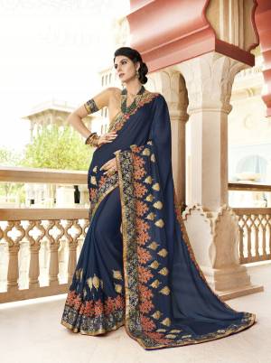 Enhance Your Personality Wearing This Designer Saree In Dark Blue Color Paired With Beige Colored Blouse. This Saree Is Fabricated On Chiffon Paired With Art Silk Fabricated Blouse. It Is Beautified With Contrasting Embroidery Making It More Attractive.