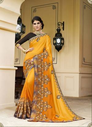 Celebrate This Festive Season Wearing This Designer Saree In Yellow Color Paired With Contrasting Brown Colored Blouse. This Saree Is Fabricated On Silk Georgette Paired With Art silk Fabricated Blouse. It Has Attractive Embroidery Over The Saree. Buy Now.