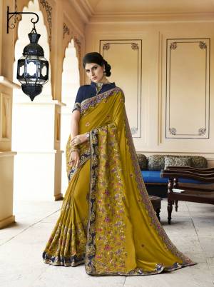 New And Unique Shade Is Here To Add Into Your Wardrobe, Grab This Designer Saree In Pear Green Color Paired With Contrasting Dark Blue Colored Blouse. This Saree Is Fabricated On Soft Silk Paired With Art Silk Fabricated Blouse. It Has Contrasting Floral Embroidery Over The Saree. 