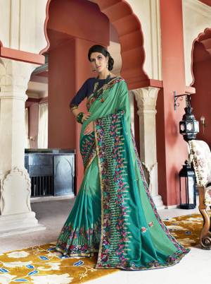 Add This Beautiful Designer Saree To Your Wardrobe In Sea Green Color Paired With Contrasting Navy Blue Colored Blouse. This Saree Is Soft Silk Based Fabric Paired With Art Silk Fabricated Blouse. It Is Easy To Drape And Also Durable. Buy Now.