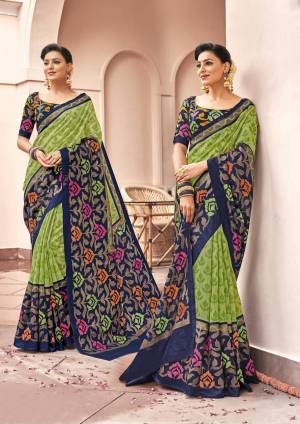 This Festive Season Have A Rich And Elegant Look Wearing This Saree In Green Color Paired With Contrasting Navy Blue Colored Blouse. This Saree And Blouse Are Fabricated On Art Silk Beautified With Bold Prints All Over.