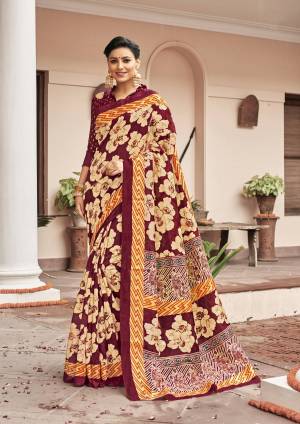 You Will Earn Lots Of Compliments Wearing This Silk Based Saree In Maroon And Cream Color Paired With Maroon Colored Blouse. Its Fabric And Color Gives A Rich Look To Your Personality.