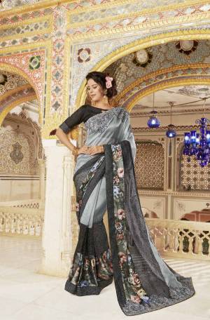 Flaunt Your Rich And Elegant Taste Wearing This Beautiful Designer Saree In Grey Color Paired With Black Colored Blouse. This Saree Is Fabricated On Fancy Silk Paired With Art Silk Fabricated Blouse. It Is Beautified With Floral Prints And Embroidery Making The Saree Attractive. Buy Now.