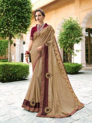 Rich And Elegant looking Designer Saree Is Here In Beige Color Paired With Maroon Colored Blouse. This Saree Is Fabricated On Chiffon Georgette Paired With Art Silk Fabricated Blouse. Its Elegant Embroidery Color Combination Will Earn You Lots Of Compliments From Onlookers. 