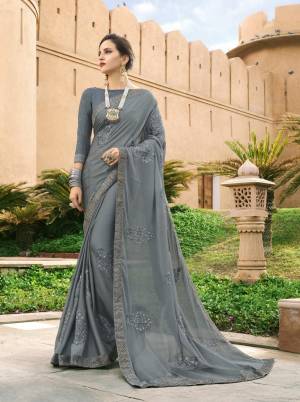 Flaunt Your Rich And Elegant Taste Wearing This Designer Saree In Grey Color Paired With Grey Colored Blouse. This Saree Is Fabricated On Silk Georgette Paired With Art Silk Fabricated Blouse. It Has Tone To Tone Embroidered Motifs With Lace Border.