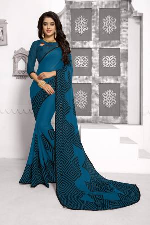 Enhance Your Personality Wearing This Rich And Elegant Looking Saree In Blue Color Paired With Blue Colored Blouse. This Saree And Blouse Are Fabricated On Chiffon Beautified With Simple Geometric Prints. Buy Now.