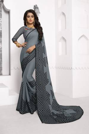 Flaunt Your Rich And Elegant Taste Wearing This Elegant Looking Grey Colored Saree Paired With Grey Colored Blouse. This Saree And Blouse are Chiffon Based Fabric Beautified With Prints. Buy This Saree Now.
