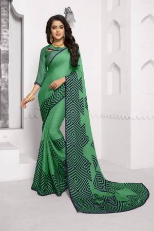 For Your Casual Or Semi-Casual Wear, Grab This Pretty Saree In Green Color Paired With Green Colored Blouse. This Saree And Blouse Are Chiffon Based Fabric Beautified With Simple Prints. Buy Now.