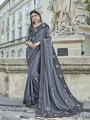 Flaunt Your Rich and Elegant Look Wearing This Designer Saree In Grey Color Paired With Black Colored Blouse. This Saree Is Fabricated On Silk Chiffon Paired With Velvet And Net Fabricated Blouse. 