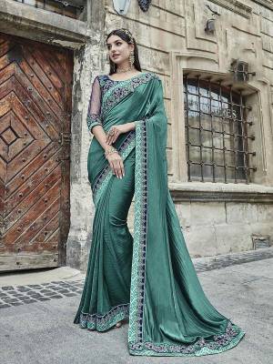 Add This Lovely Designer Saree To Your Wardrobe In Sea Green Color Paired With Navy Blue Colored Blouse. This Silk Based Saree Is Paired With Art Silk And Net Fabricated Blouse. It Has Embroidered Lace Border And Blouse. 
