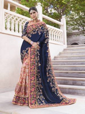 Here Is A Beautiful Designer Heavy Saree In Navy Blue And Peach Color Paired With Peach Colored Blouse. ThisSaree IS Fabricated On Silk And Silk Georgette Paired With Art Silk Fabricated Blouse. It Has Heavy Embroidery All Over Which Is Making The Saree More Attractive. 