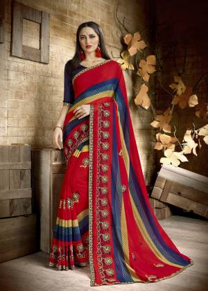 Bright And Visually Appealing Color Is Here In Red Color Paired With Navy Blue Colored Blouse. This Saree Is Fabricated On Georgette Paired With Art Silk Fabricated Blouse. It Has Simple Prints And Thread Work Over The Saree.