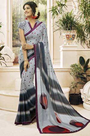 Flaunt Your Rich And Elegant Taste Wearing This Printed Saree In Grey Color Paired With Grey Colored Blouse. This Saree And Blouse Are Fabricated On Georgette Beautified With Prints All Over. Its Pretty Color And Simple Print Will Give An Elegant Look To your Personality. Buy Now.