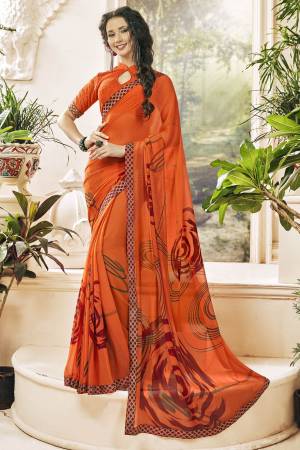 Orange Color Induces Perfect Summery Appeal To Any Outfit, So Grab This Attractive Looking Saree In Orange Color Paired With Orange Colored Blouse. This Saree And Blouse Are Fabricated On Georgette Beautified With Prints.