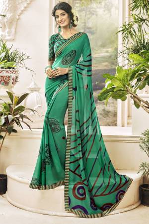 For Your Casual Wear, Grab This Saree In Green Color Paired With Green Colored Blouse. This Saree And Blouse are Georgette Based Fabric Beautified With Prints. It Is Light Weight And Easy To Carry All Day Long.