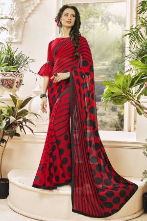 Adorn The Pretty Angelic Look Wearing This Saree In Red Color Paired With Red Colored Blouse. This Saree And Blouse are Georgette Based Beautified With Polka Dots And Lining Prints. 