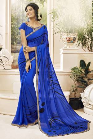 Shine Bright Wearing This Saree In Royal Blue Color Paired With Royal Blue Colored Blouse. It Has Georgette Based Fabric Beautified With Very Simple And Less Prints. It Is Light Weight And Also Durable. 