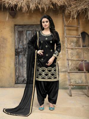 Enhance Your Personality Wearing This Designer Salwar Suit In Black Color. This Semi-Stitched Suit Has Art Silk Fabricated Top Paired With Santoon Bottom And Net Dupatta. It Is Beautified With Jari Embroidery and Mirror Work. Buy This Attractive Looking Suit Now.