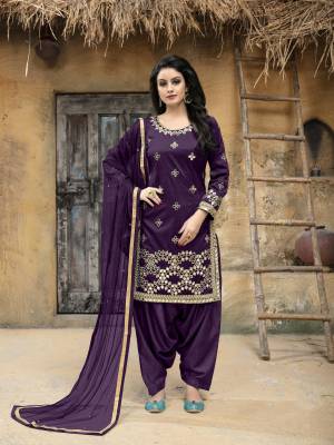 Enhance Your Personality Wearing This Designer Salwar Suit In Purple Color. This Semi-Stitched Suit Has Art Silk Fabricated Top Paired With Santoon Bottom And Net Dupatta. It Is Beautified With Jari Embroidery and Mirror Work. Buy This Attractive Looking Suit Now.
