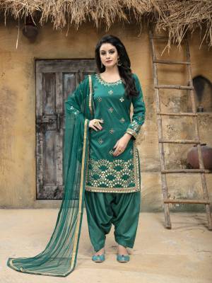 Enhance Your Personality Wearing This Designer Salwar Suit In Sea Green Color. This Semi-Stitched Suit Has Art Silk Fabricated Top Paired With Santoon Bottom And Net Dupatta. It Is Beautified With Jari Embroidery and Mirror Work. Buy This Attractive Looking Suit Now.
