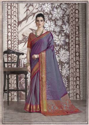 You Will Definitely Earn Lots Of Compliments Wearing This Designer Silk Saree In Dark Purple Color Paired With Orange Colored Blouse. This Saree And Blouse Are Banarasi Muslin Silk Based Fabric Beautified With Weave. Buy This Saree Now.