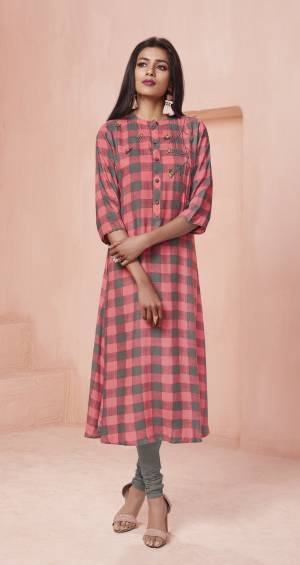 Checks Are Too Much In This Season, So Grab This Readymade Kurti In Pink And Grey Color Fabricated On Rayon Beautified With Checks Prints All Over It And Simple Thread Work. Buy This Designer Kurti Now.