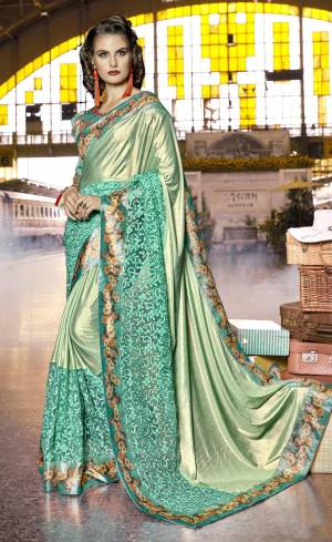 This Season Is About Subtle Shades And Pastel Play, So Grab This Designer Saree In Pastel Green color paired With Green Colored Blouse. This Saree Is Fabricated On Lycra And Net Paired With Art Silk Fabricated Blouse. It Has Lovely Prints And Fancy Work Which Is Making The Saree Attactive. Buy Now.