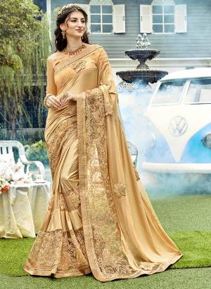 Simple And Elegant Looking Designer Saree Is Here In Golden Color Paired With Golden Colored Blouse. This Saree Is Fabricated On Lycra And Net Paired With Art Silk Fabricated Blouse. It Is Beauitified With Heavy Embroidery Making The Saree Attractive. 