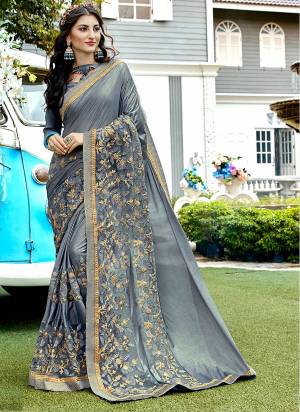 Flaunt Your Rich And Elegant Taste Wearing This Designer Saree In Grey Color Paired With Grey Colored Blouse, This Saree Is Fabricated On Lycra And Net Paired With Art Silk Fabricated Blouse. It Has Pretty Attractive Embroidery Which Will earn You Lots Of Compliments From Onlookers.