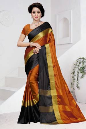 Add This New Shade To Your Wardrobe With This Poly Cotton Based Saree In Rust Orange Color Paired With Rust Orange Colored Blouse. This Saree Has Black And Gold Patta Which Is Giving An Attractive Look.