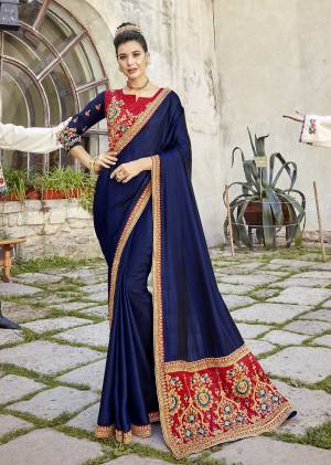 Grab This Attractive Looking Navy Blue Colored Designer Saree Paired With Contrasting Red Colored Blouse. This Saree Is Satin Silk Based Fabric Paired With Art Silk Blouse. Both Thr Fabric Gives A Rich Look To Your Personality.
