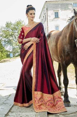For A Royal Look, Grab This Heavy Designer Saree In Maroon Color Paired With Contrasting Peach Colored Blouse. This Saree Is Satin Silk Based Fabric Paired With Art Silk Fabricated Blouse. It Has Heavy Coding And Resham Work Making The Saree More Attractive. Buy Now.