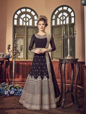 A Must Have Shade In Dark Is Here With This Heavy Designer Floor Length Suit In Dark Wine Color Paired With Dark Wine Colored Bottom And Dupatta. Its Long Heavy Top Is Georgette Based Paired With Santoon Bottom And Chiffon Dupatta. It Has Heavy Jari Embroidery Giving A Rich And Elegant Look To The Suit.