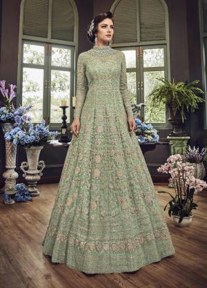Add This Beautiful Heavy Designer Floor Length Suit In Mint Green Color Paired With Mint Green Colored Bottom And dupatta. Its Top And Dupatta Are Net Fabricated Paired With Art Silk Bottom. Also Its Top Is Beautified With Heavy Embroidery All Over.