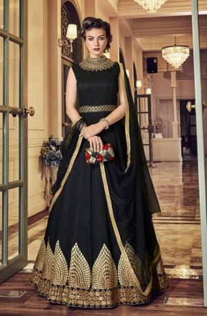 For A Bold And Beautiful Look, Grab This Designer Floor Length Suit In Black Color Paired With black Colored Bottom And Dupatta. Its Top IS FabricatedOn art Silk Paired With Santoon Bottom And Net Dupatta. It Has Rich Elegant Embroidery Over The panel And NEck. 