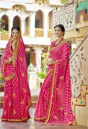 Look Beautiful In This Designer Bandhani Saree In Dark Pink Color Paired With Dark Pink Colored Blouse. This Saree Is Fabricated On Chiffon Paired With Art Silk Fabricated Blouse. It Is Beautified with Prints And Embroidered Lace Border. Buy Now.