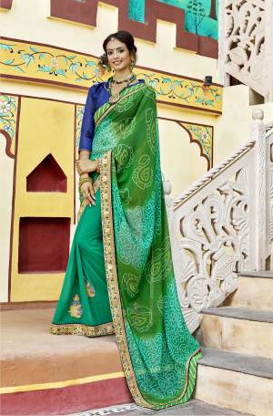 Celebrate This Festive Season Wearing This Bandhani Printed Saree In Green Color Paired With Royal Blue Colored Blouse. This Saree Is Georgette Based Paired With Art Silk  Blouse. It Also Has Attractive Embroidered Lace Border.