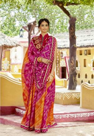 Look Beautiful In This Designer Bandhani Saree In Dark Pink And Orange Color Paired With Red Colored Blouse. This Saree Is Fabricated On Chiffon Paired With Art Silk Fabricated Blouse. It Is Beautified with Prints And Embroidered Lace Border. Buy Now.