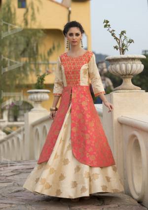 Celebrate This Festive Season Wearing This Heavy Looking Designer Gown In Orange And Cream color Fabricated On Art Silk. This Gown IS Available In All Regular Sizes, So Choose Accordingly. Buy Now.