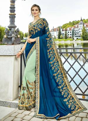 You Will Definitely Earn Lots Of Compliments Wearing This Heavy Designer Saree With Beautiful Color Pallete. This Saree Is In Blue And Pastel Green Color Paired With Beige Colored Blouse. This Saree Is Fabricated On Lycra And Georgette Paired With Art Silk Fabricated Blouse. It Is Beautified With Heavy Attractive Embroidery. 