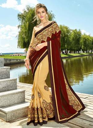 Adorn A Royal Queen Like Look Draping This Heavy Designer Saree In Maroon And Beige Color Paired With Beige Colored Blouse. This Saree Is Fabricated On Georgette Paired With Art Silk Fabricated Blouse. This Saree Will Give A Rich Look To Your Personality Like Never Before. 