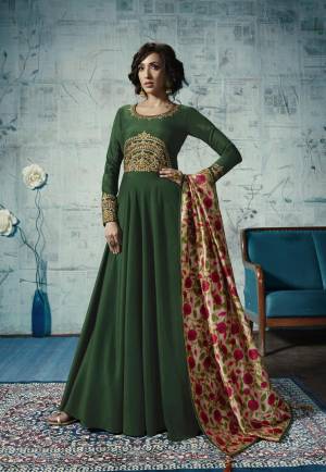 For An Attractive Look, Grab This Designer Readymade Floor Length Gown In Dark Green Color Fabricated On Muslin Paired With Cream Colored Tussar Silk Printed Dupatta. Buy This Now.
