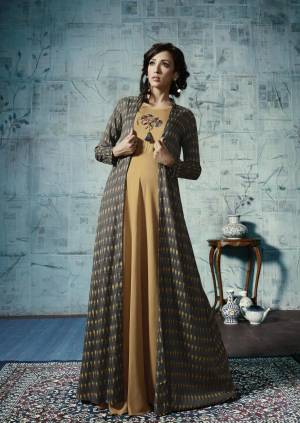 Get Ready For The Upcoming Festive Season, With This Designer Floor Length Gown In Beige And Dark Grey Color .It Is Fabricated Rayon With Ikkat Printed Jacket. Its Fabrics Are Soft Towards Skin And Easy To Carry All Day Long.